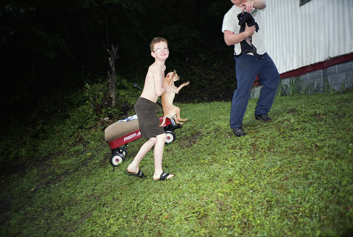 Bertien van Manen, Moonshine, Boy with dog, Cumberland, 2013