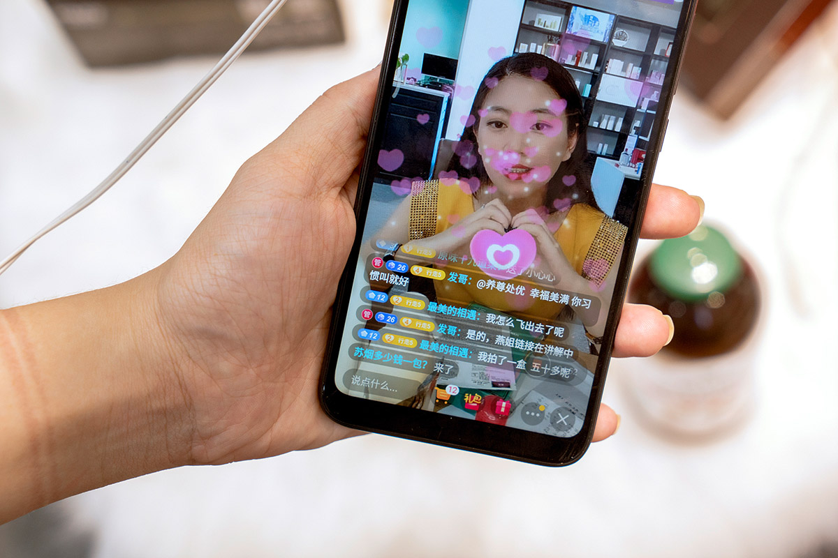 Ruben Lundgren, Yiwu, 2020, In a tight yellow dress, with perfect make-up and skin bleached by beauty filters, Wang Xiaoyan recommends her products. Since exports came to a standstill due to the corona crisis, Chinese entrepreneurs have entered the home market with sales via live streaming, a very popular activity in China.