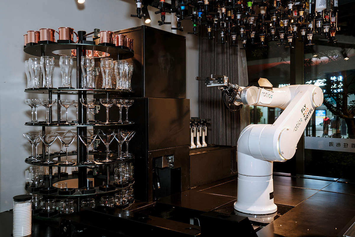 Ruben Lundgren, Hangzhou, 2019, In the Flyzoo Hotel cafe of the largest internet company Alibaba, the bartender has been replaced by a hydraulic robotic arm that prepares cocktails in full swinging and swaying modus. It can measure every drink down to the millimeter, knows five shake and stir techniques, and in the long run can be cheaper than its human colleague.