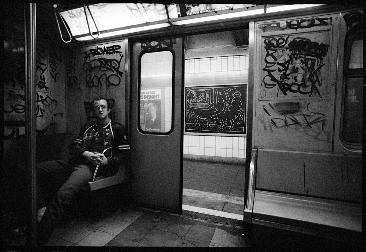 Keith Haring drawing in New York City Subway, New York, 1983, Photograph: Tseng Kwong Chi,  Muna Tseng Dance Projects, Inc. Artwork: Keith Haring Foundation