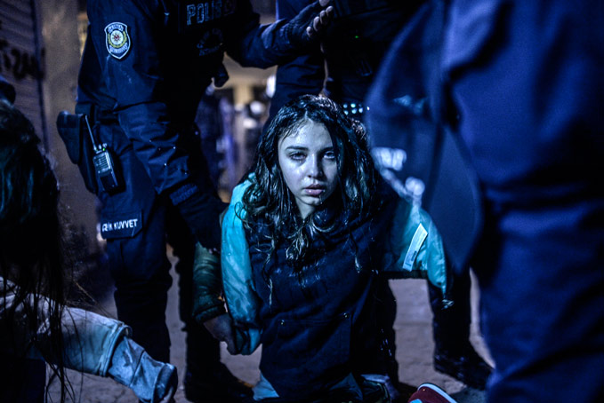 Bulent Kilic, Turkey, Agence France-Presse, First Prize Spot News Category, Singles. March 12, 2014, Istanbul, A young girl is pictured after she was wounded during clashes between riot-police and protestors after the funeral of Berkin Elvan, the 15-year-old boy who died from injuries suffered during last year's anti-government protests. Riot police fired tear gas and water cannon at protestors in the capital Ankara, while in Istanbul, crowds shouting anti-government slogans lit a huge fire as they made their way to a cemetery for the burial of Berkin Elvan.
