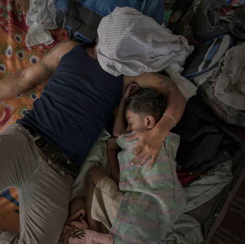 Pieter ten Hoopen, A father and son sleep after a long day's walking, Juchitán, 30 October 2018.