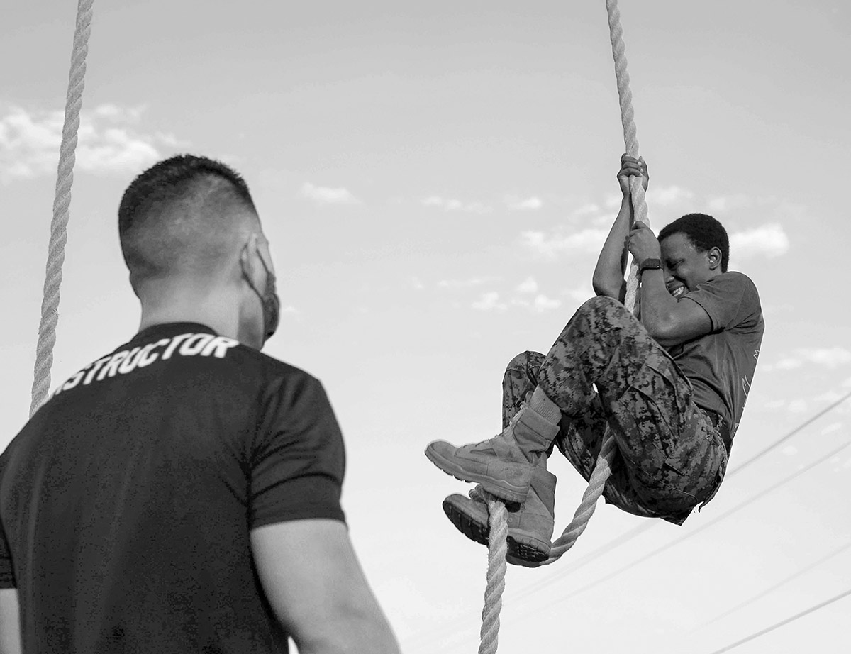 Dana Beesley, MVA Photographer of the Year, An instructor with DI School Class 1-21 corrects his student on the proper way to execute a rope climb during class physical training on Marine Corps Recruit Depot Parris Island, S.C. Oct. 15, 2020. The mission of DI School is to further develop the leadership, command presence, instructional ability, knowledge and physical condition of selected staff noncommissioned and noncommissioned officers to successfully perform the duties of a drill instructor.